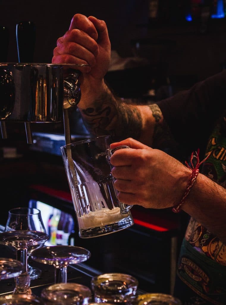 bartender pouring beer in a tap