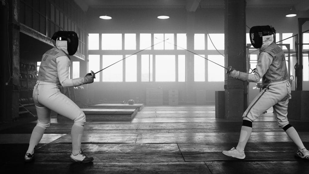 Two fencers face off in a duel