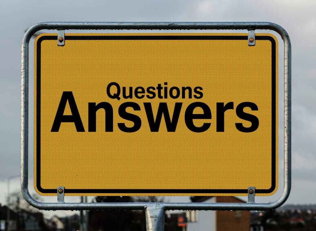 Yellow sign with black text that reads "Questions Answers"