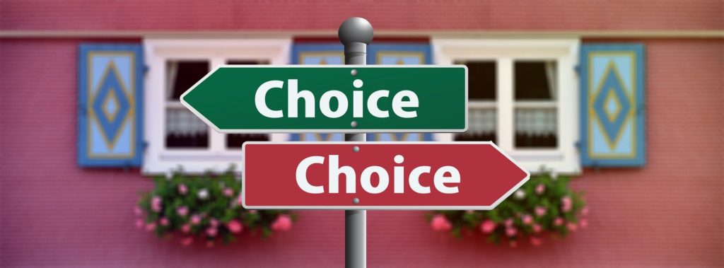 Two signs that both say choice, one red and one green.