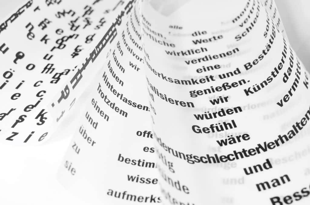 White sheets of paper with various German words printed on them.