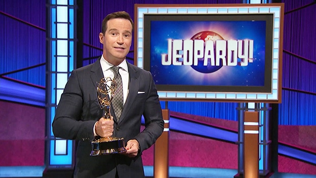 Former Jeopardy! host and executive producer Mike Richards holding an Emmy on the Jeopardy! set.