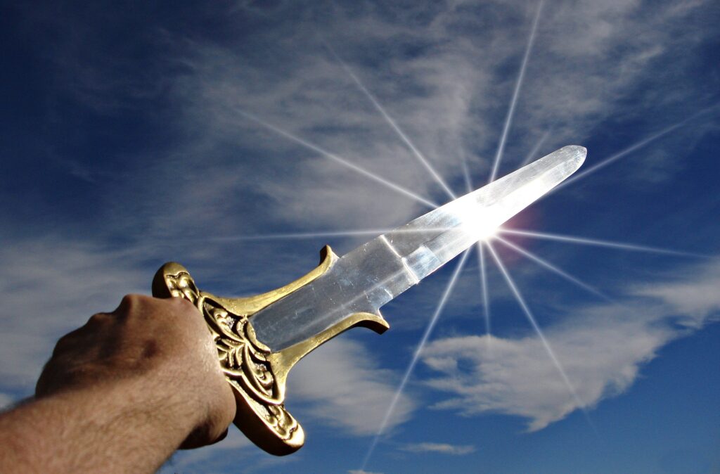 A glistening sword being pointed to the sky