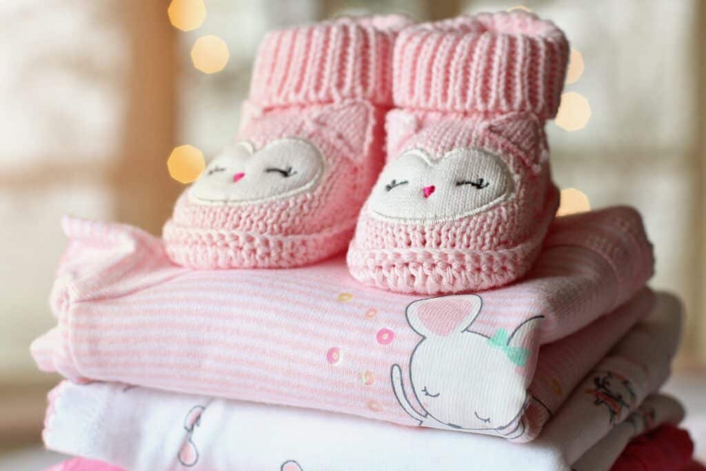 Pink baby booties and blankets