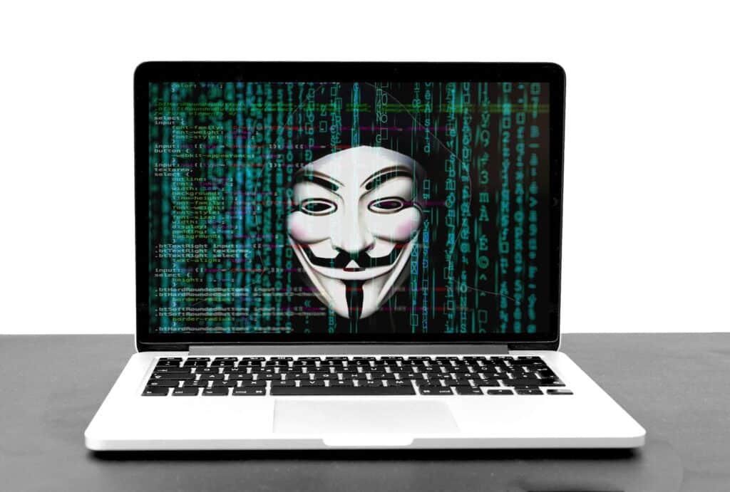 Anonymous face on a hacked laptop screen
