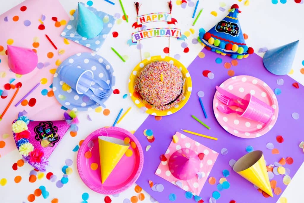 Pastel-colored birthday party decorations and utensils