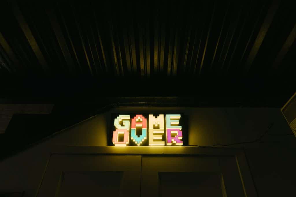 Neon lights spelling out "GAME OVER" in a video game font