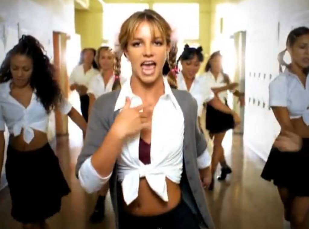 Britney Spears in pigtails and a schoolgirl uniform.