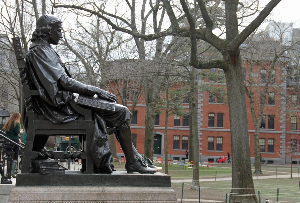 John Harvard statue outside the university.