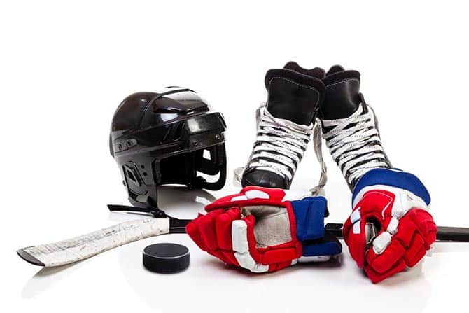 Ice hockey helmet, pads, skate, stick, and puck