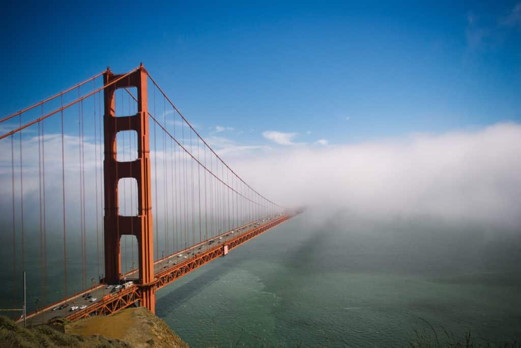 Fog surrounding the Golden Gate Bridge at day