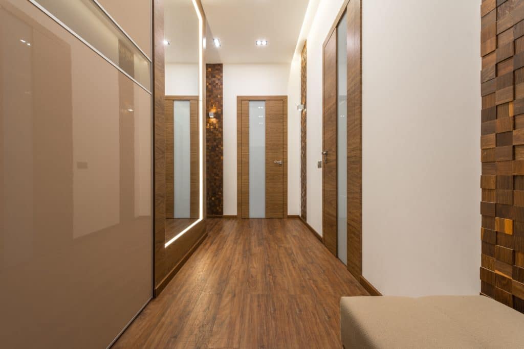A hallway with wooden floors and doors to various rooms