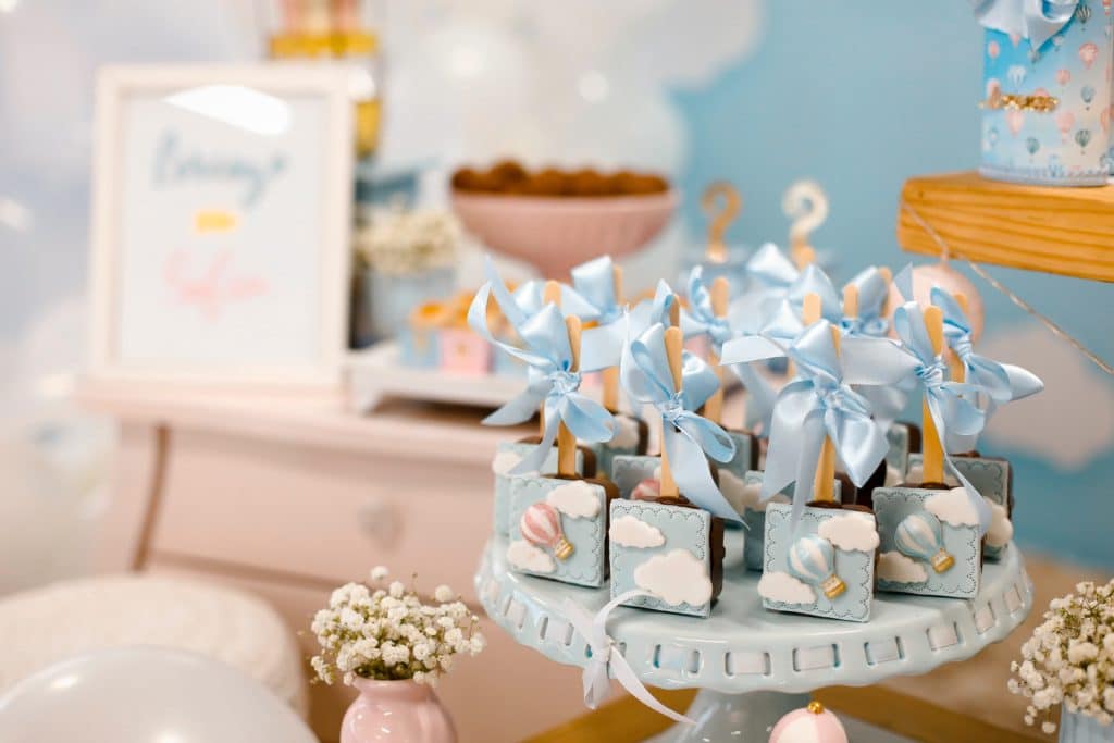 Blue treats, decorations, and a sign at a baby shower