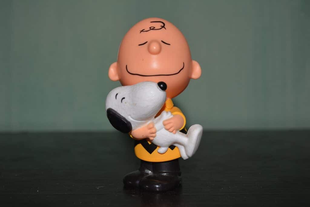 Charlie Brown holding Snoopy figurine