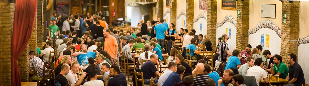 Tables of groups of people in a crowded bar for trivia night