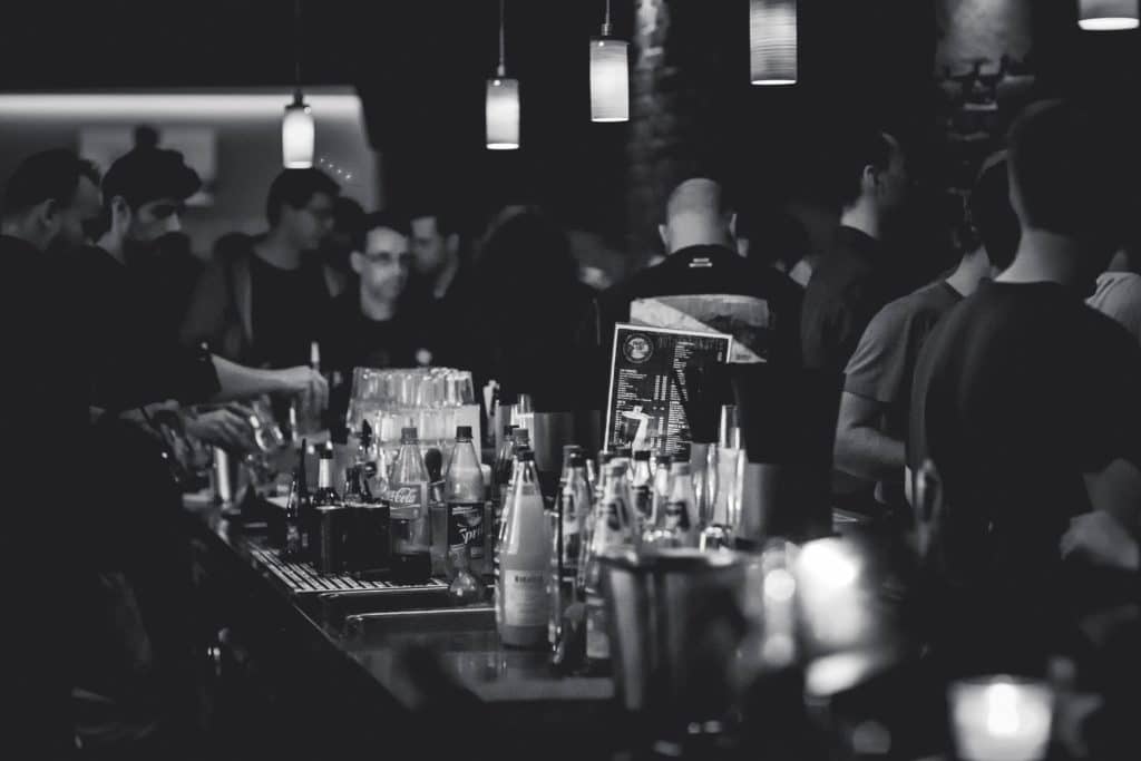 Black and white photo of a crowded bar