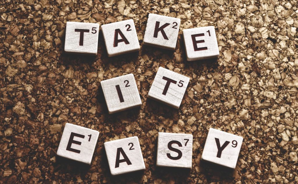 Scrabble letters spelling out the phrase "Take it Easy"