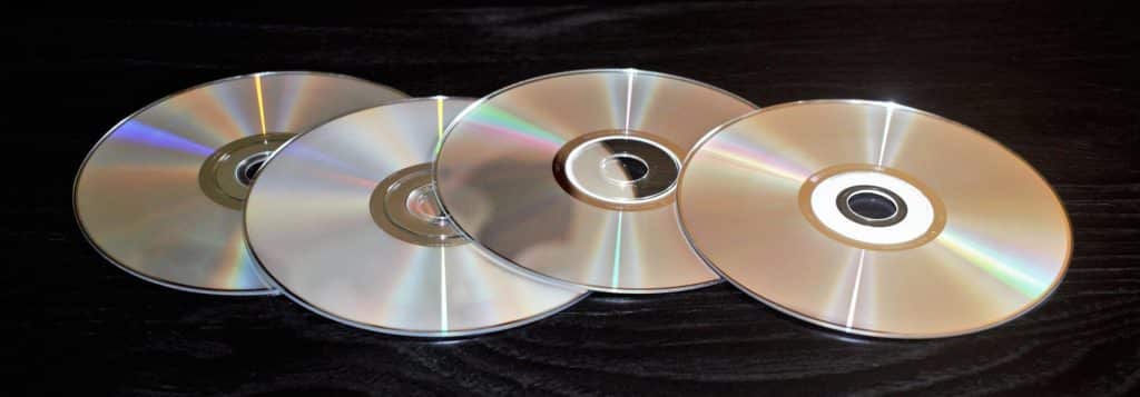 Four CDs and DVDs lined up in a row
