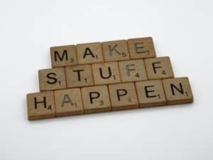 Scrabble letters spelling out "make stuff happen"
