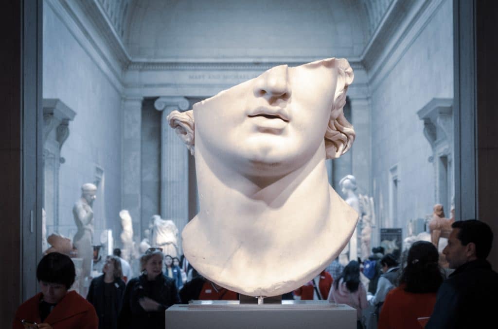 Broken white head bust in a museum