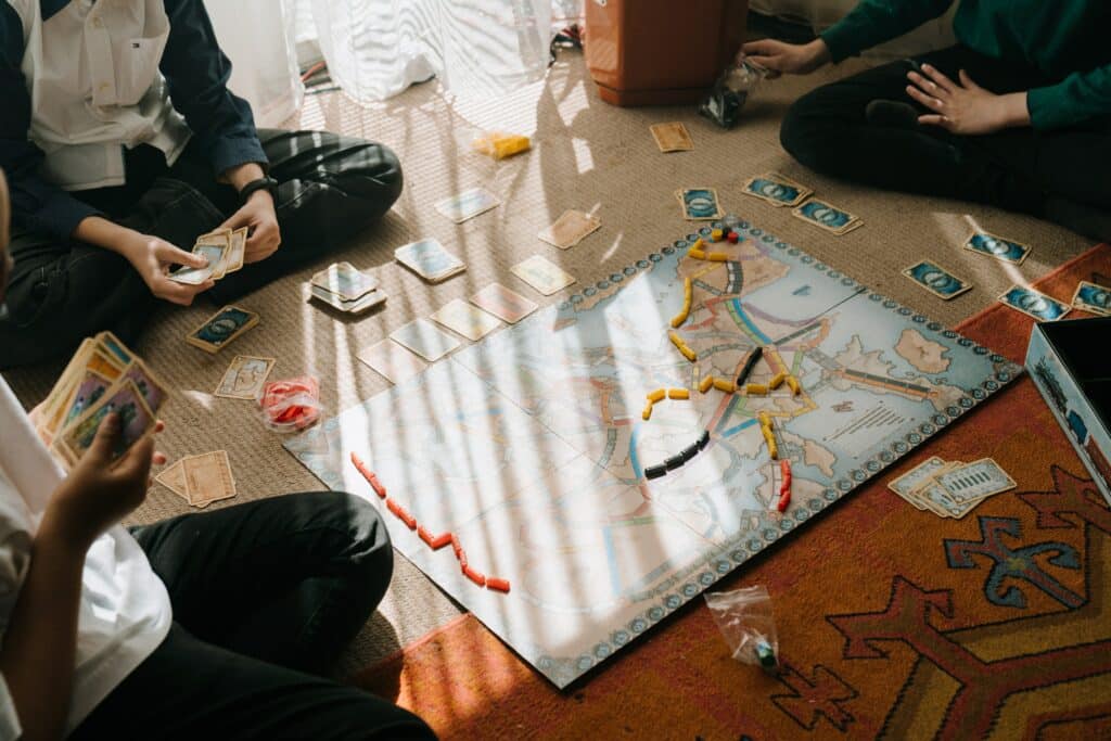 Overhead image of three young boys playing a board game