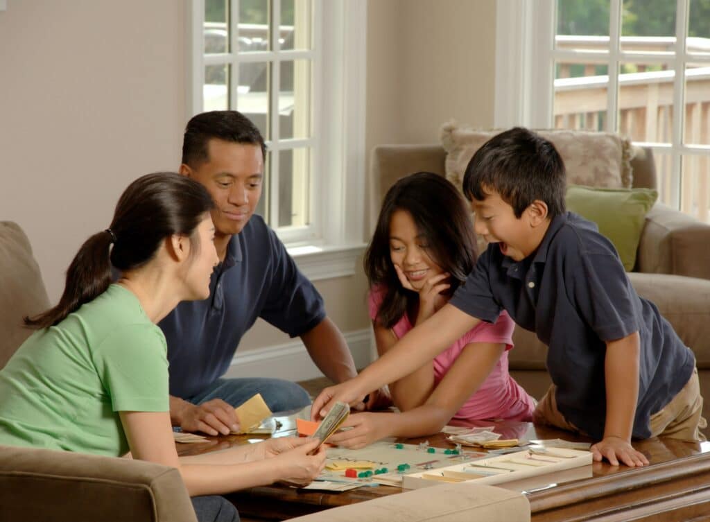 A photo of a family playing a board game together.