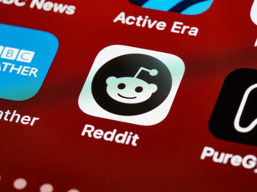 Photo of the Reddit app icon on a smartphone