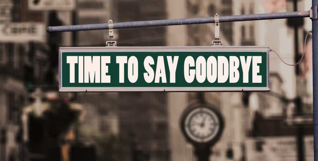A green street sign that reads "TIME TO SAY GOODBYE"