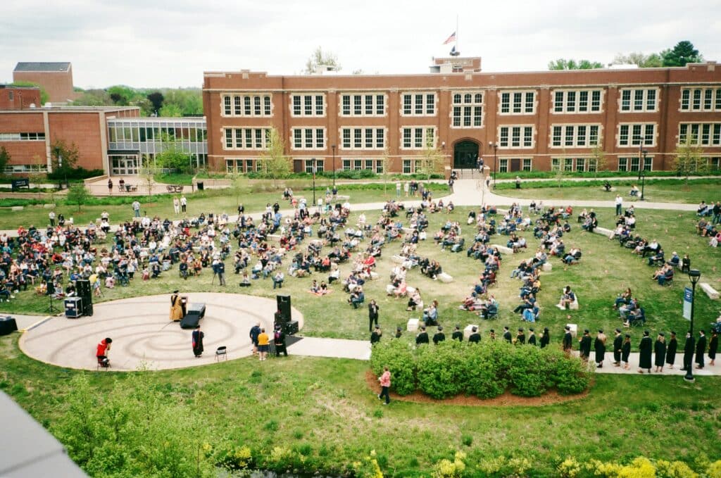 Photo of a graduation ceremony taking place on a college campus