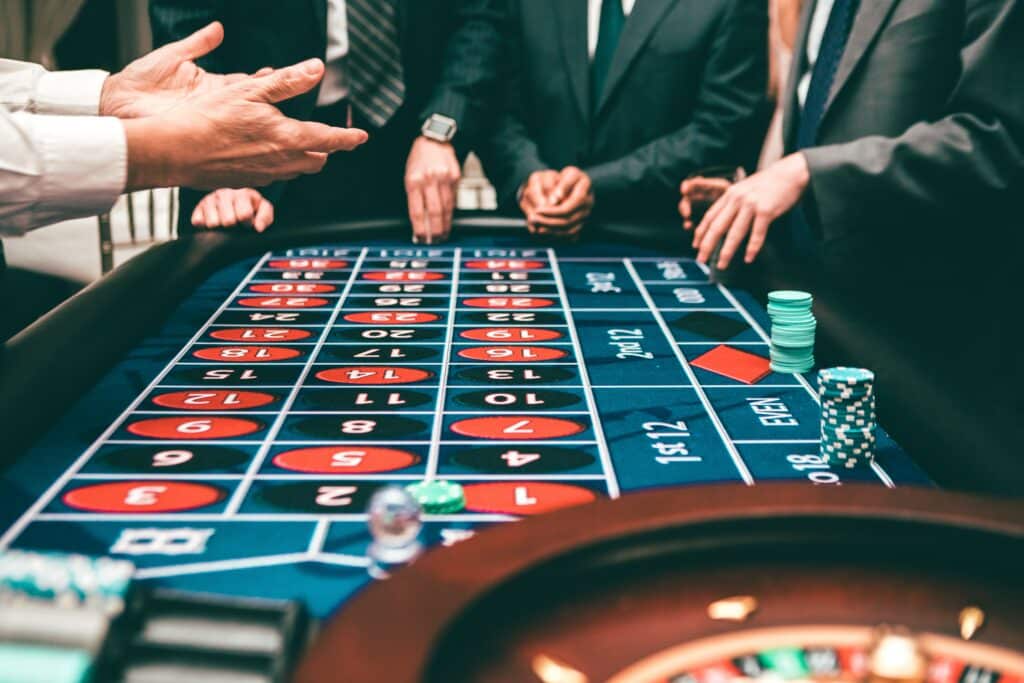 Men in business suits playing a game of roulette