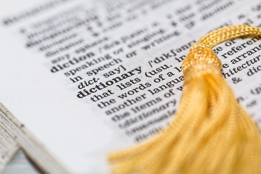 Close up of the word and definition of the word "dictionary" in a dictionary