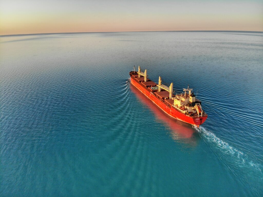Photo of a red and white cargo ship on Lake Huron