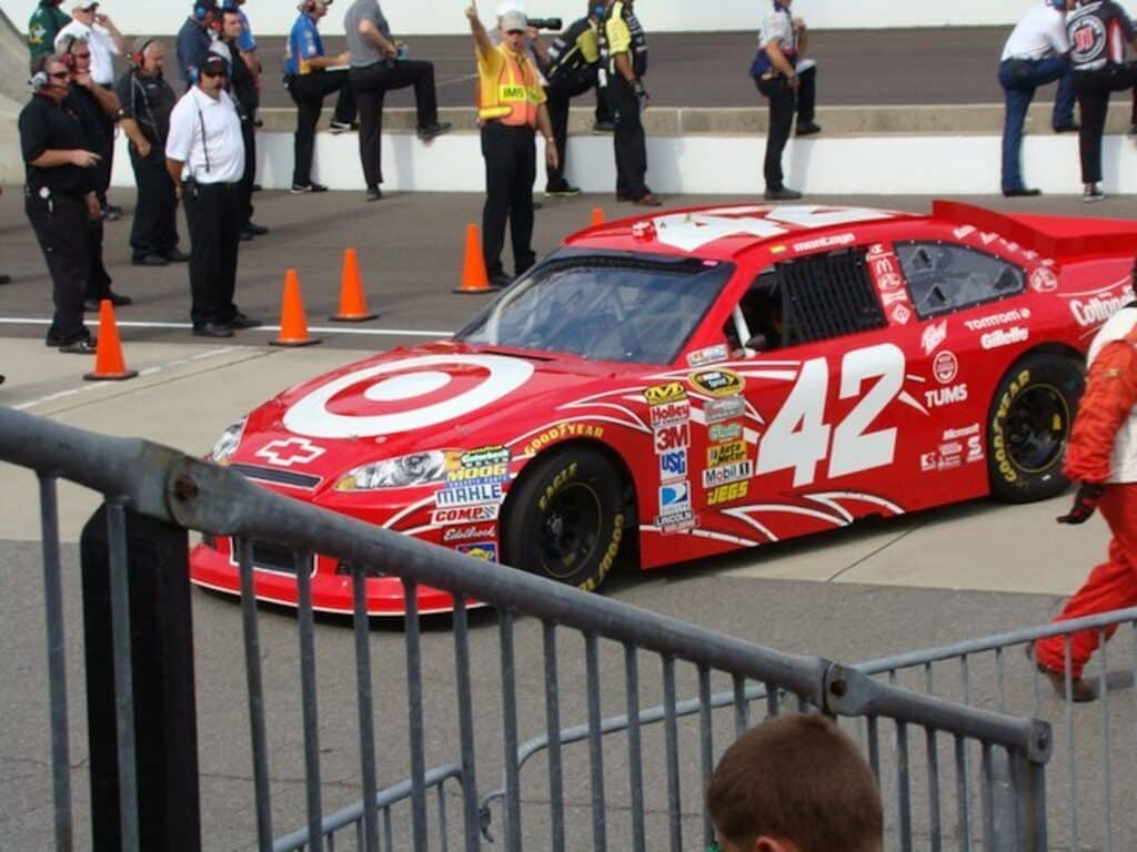 Photo of a red racecar on a motor speedway