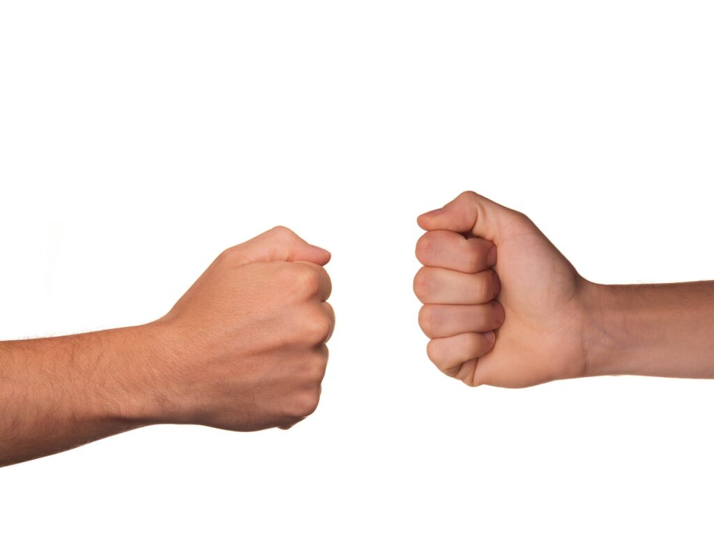 Two hands making fists, displaying a tie in rock, paper, scissors