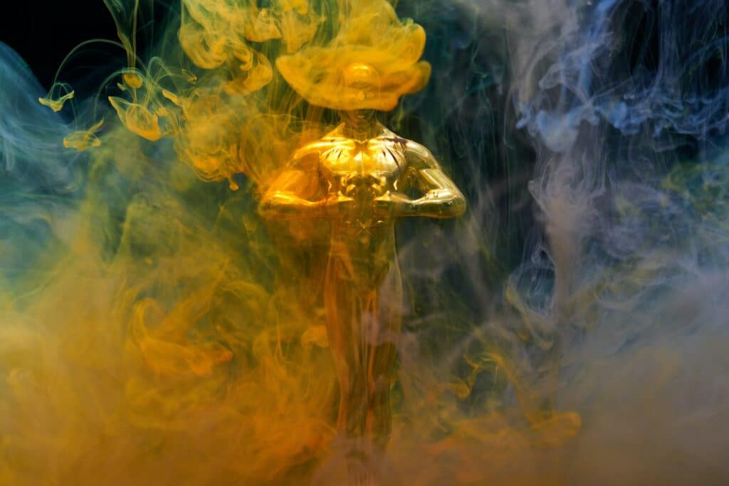 Photo of an Oscar engulfed in blue and yellow smoke
