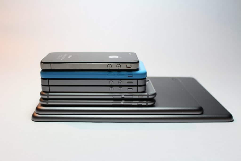 Assorted iPhones stacked on top of one another. 