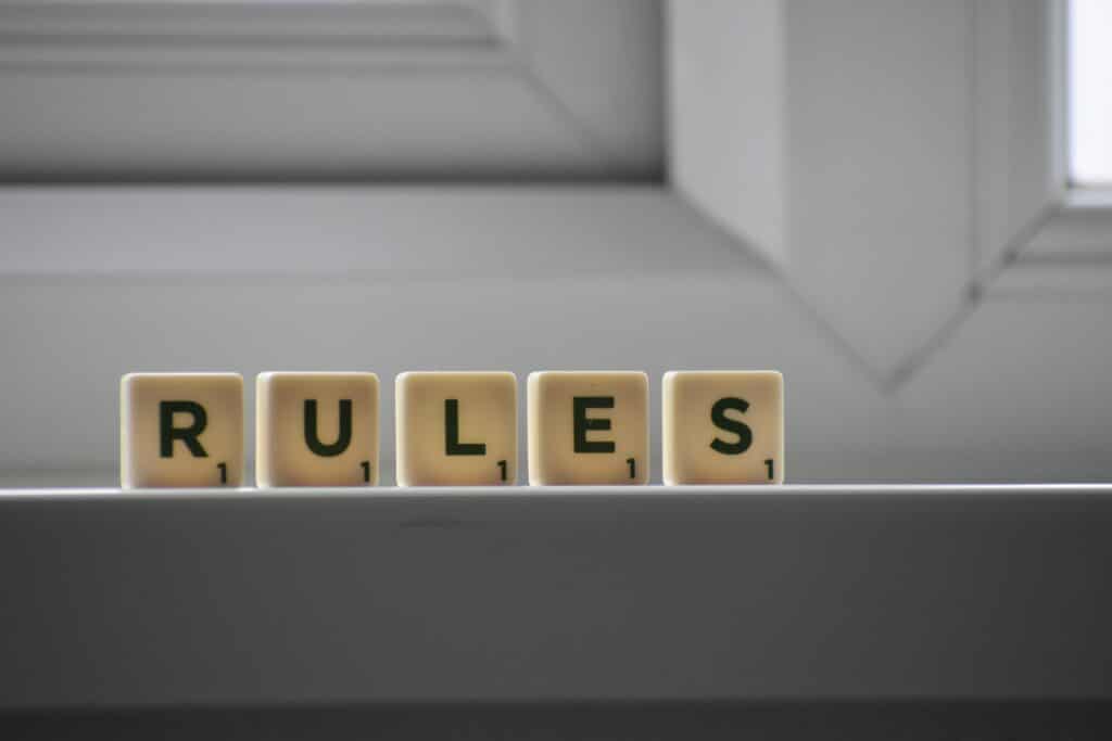 Scrabble letters spelling out the word "RULES"