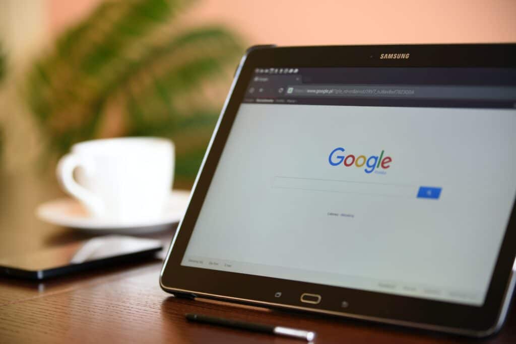 Photo of a tablet on a table displaying the Google search screen 