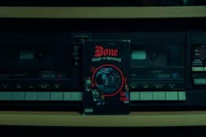 Photo of a Bone Thugs-n-Harmony cassette tape in front of a cassette player.