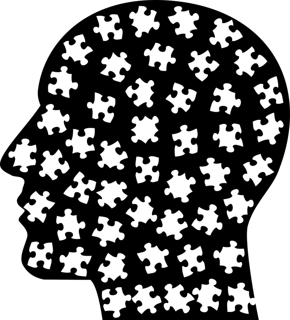 Black and white vector image of a human head made up of puzzle pieces