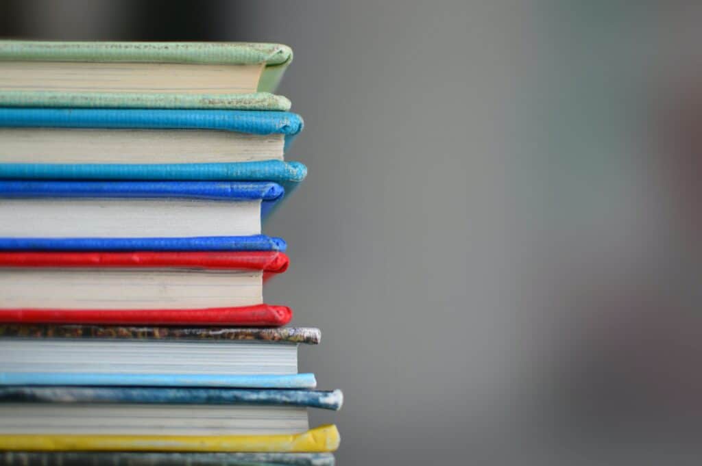 Photo of a stack of multicolor textbooks