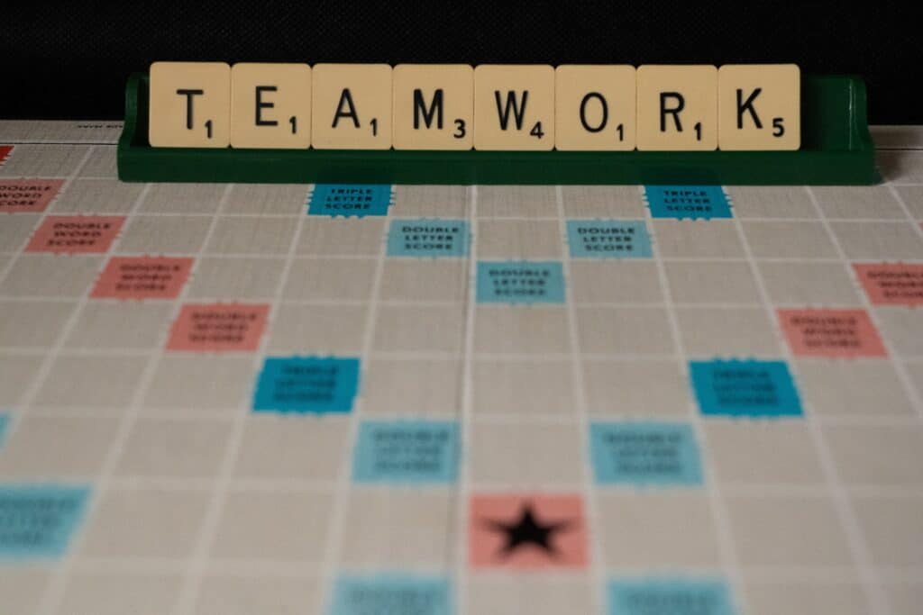 Scrabble letters spelling out the word "TEAMWORK"