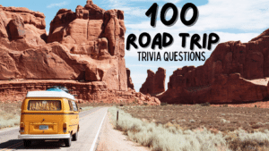 Photo of an old-school yellow RV on a long stretch of winding road in a desert, surrounded by rock formations. Text against the blue sky reads "100 Road Trip Trivia Questions"