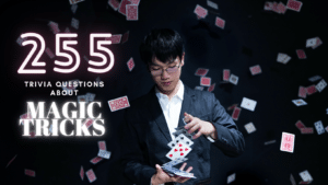 Photo of a young magician shuffling cards with cards thrown in the air around him against a black background, and text next to it that reads "255 trivia questions about magic tricks"