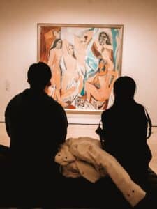 Two people looking at a Picasso painting in the MoMA