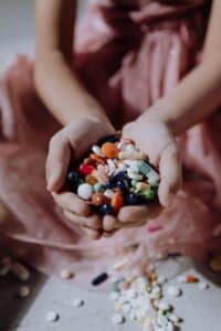 A woman holding a handful of pills