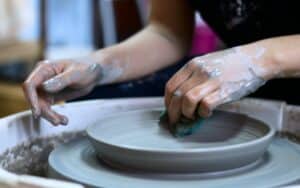 Hands shaping clay