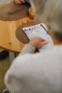 An old person solving a sudoku puzzle