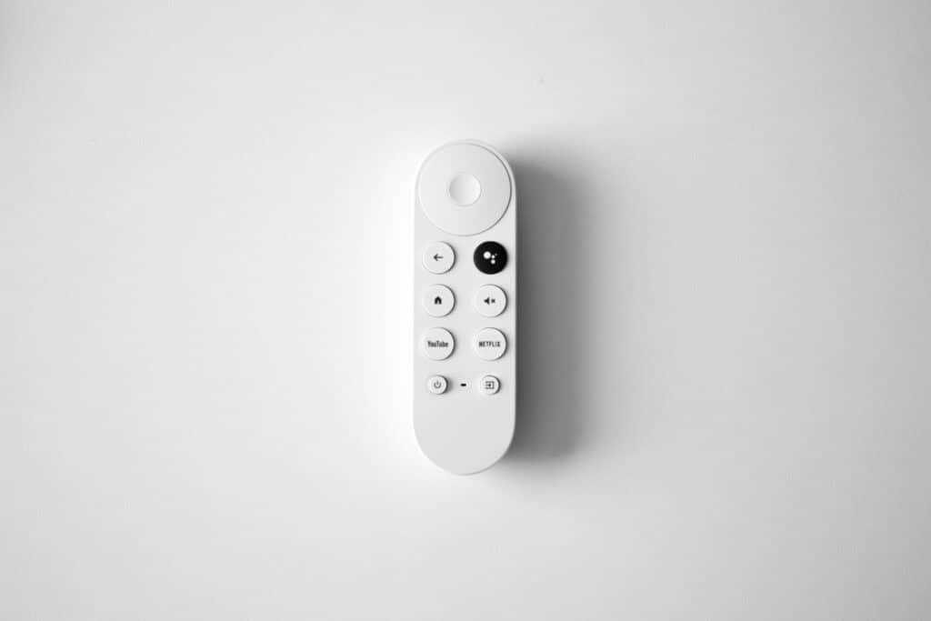 Photo of a white Google Chromecast controller against a white background. 