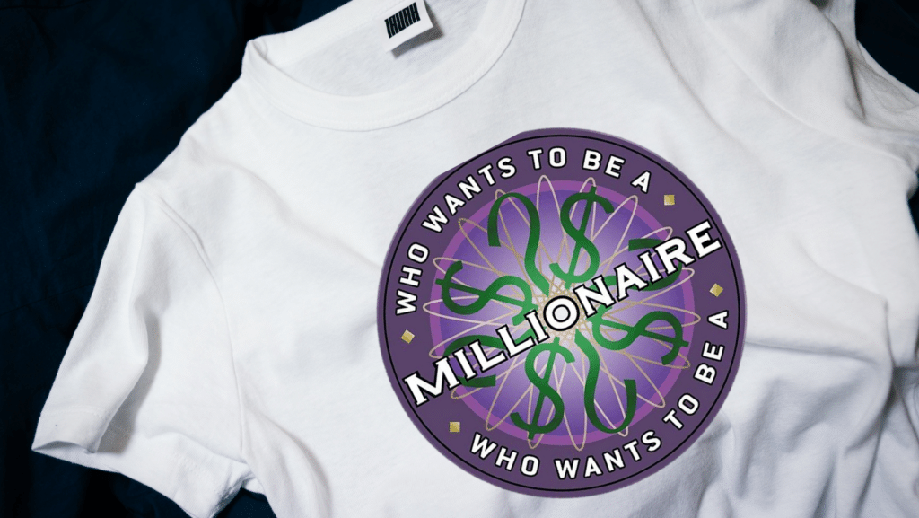 Photo of a plain white t-shirt with the "Who Wants to Be a Millionaire?" logo on it, against a black background.
